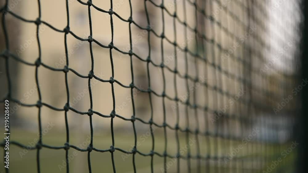 Slow Motion Tracking Wide Shot of Soccer Football Field through Chainlink Fence on Day Slow Motion Tracking Wide Shot of Soccer Football Field through Chainlink Fence on Day