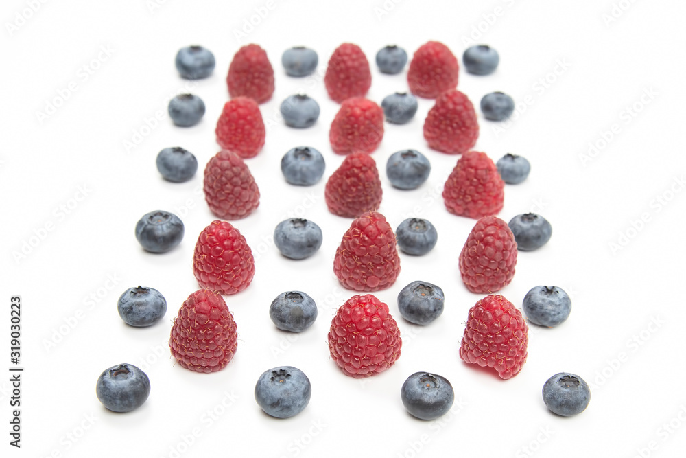 raspberries and blueberries on a white background. Vitamins and wholesome foods raspberries and blueberries on a white background. Vitamins and wholesome foods