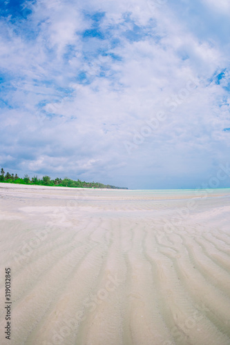 Idyllic tropical beach in Caribbean with white sand  turquoise ocean water and blue sky