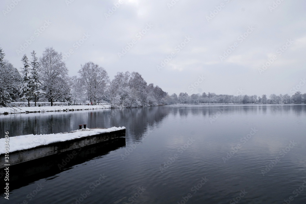 Footbridge on a lake with snow and frost, Bavaria, Germany