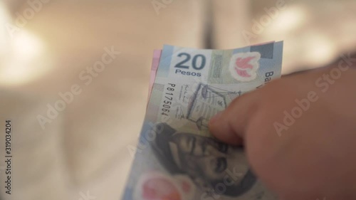 Money - hands counting mexican pesos 