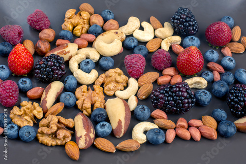 different berries and nuts on a plate. vitamin proteins and healthy foods