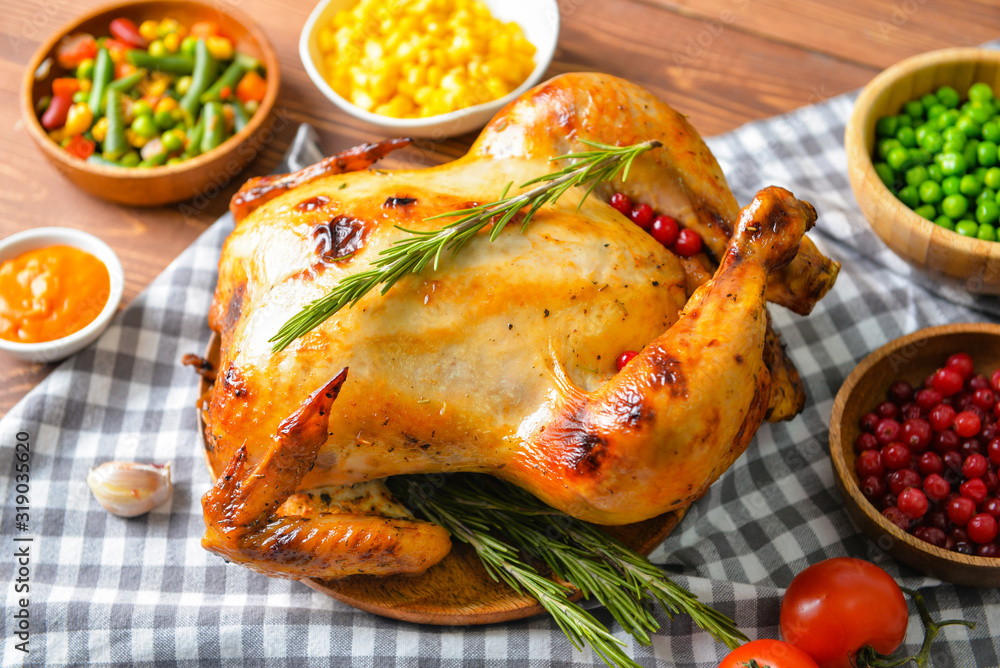 Tasty baked turkey and different food for Thanksgiving day on table Tasty baked turkey and different food for Thanksgiving day on table