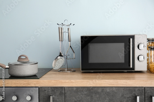 Modern microwave oven in kitchen photo