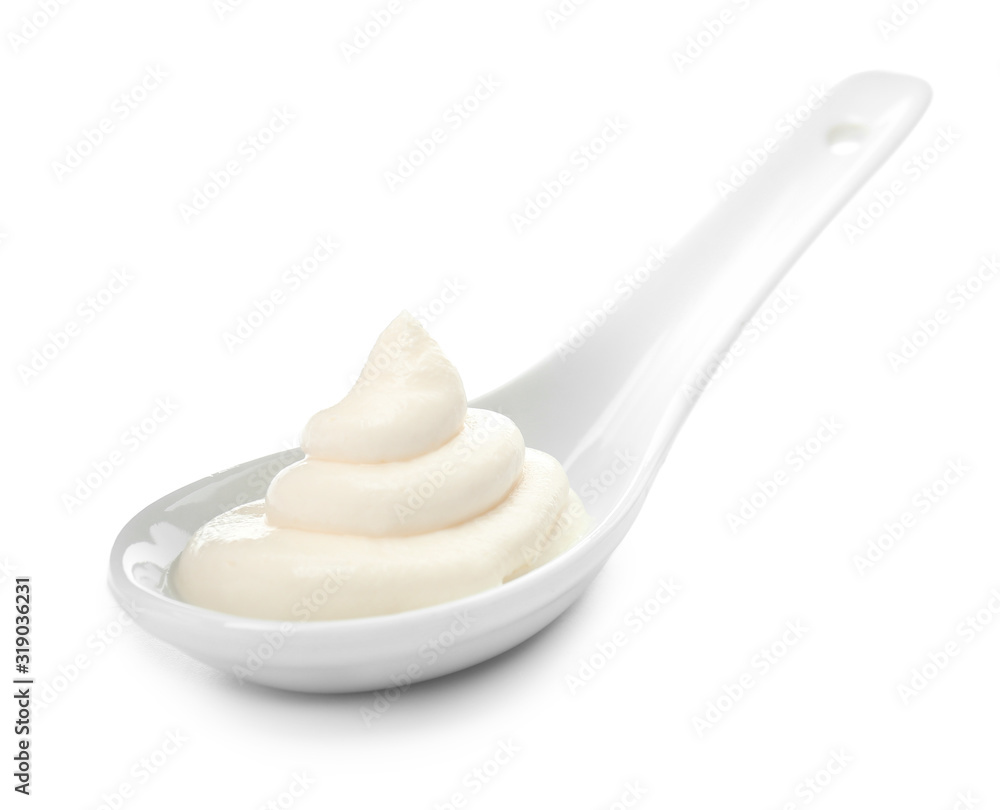 Spoon with tasty cream cheese on white background Spoon with tasty cream cheese on white background