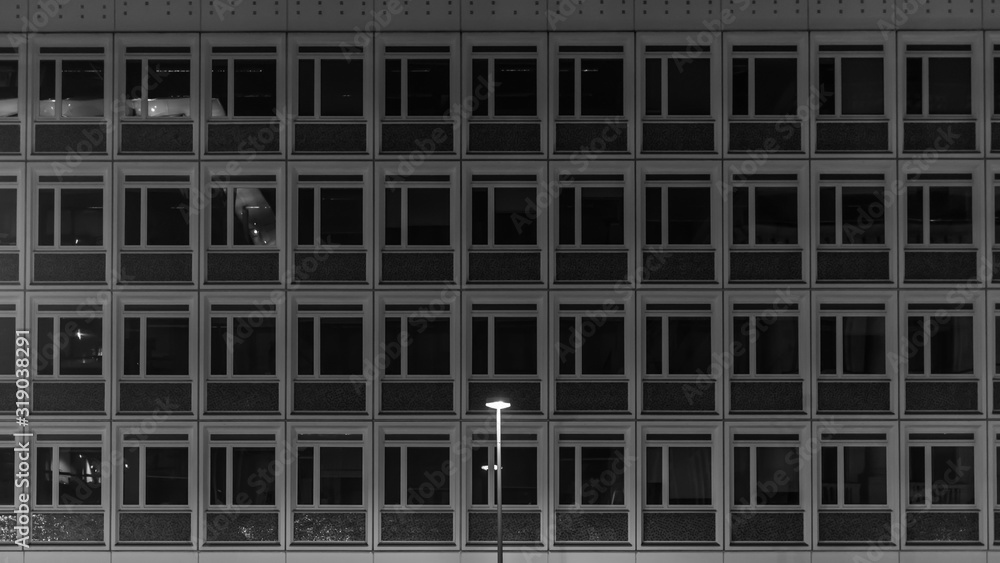 A single street lamp stands in front of a prefabricated building. Berlin, Germany. A single street lamp stands in front of a prefabricated building. Berlin, Germany.