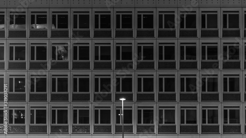 A single street lamp stands in front of a prefabricated building. Berlin, Germany.