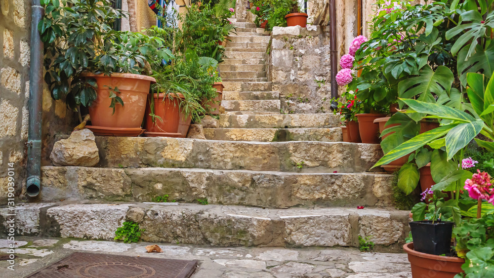 Fototapeta Mediterranean summer cityscape - view of a medieval street with stairs in the Old Town of Dubrovnik on the Adriatic Sea coast of Croatia