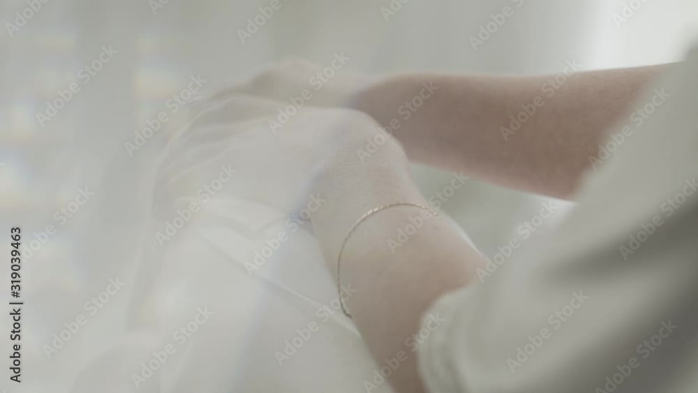 Beautiful hands of a girl in a white coat in a hotel room. Beautiful hands of a girl in a white coat in a hotel room.