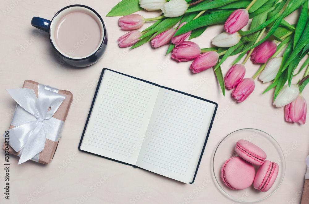 Breakfast on table. flat lay composition with flowers, a notepad a cup o coffee and sweets. Concept Hello spring Breakfast on table. flat lay composition with flowers, a notepad a cup o coffee and sweets. Concept Hello spring