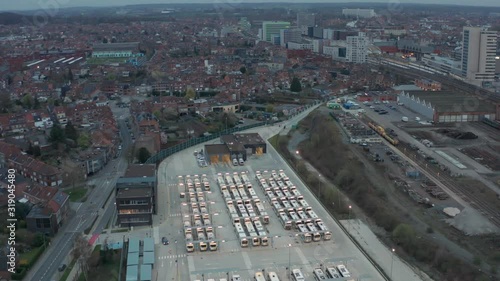 Bus station on with many busses in the morning static Aerial shot wide city view