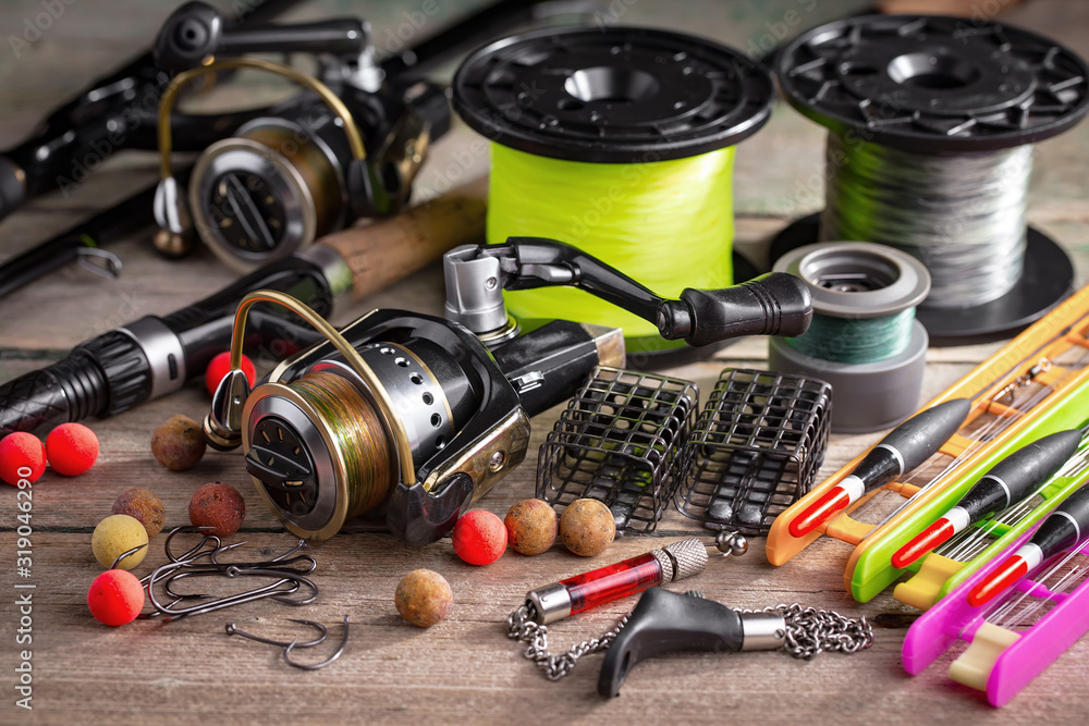 fishing tackle on a wooden table. toned image fishing tackle on a wooden table. toned image