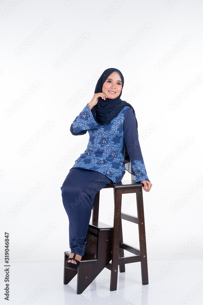 Beautiful female model in various poses wearing modern kurung and hijab, a modern urban lifestyle apparel for Muslim women isolated on white background. Beauty and hijab fashion concept. Full length. Beautiful female model in various poses wearing modern kurung and hijab, a modern urban lifestyle apparel for Muslim women isolated on white background. Beauty and hijab fashion concept. Full length.