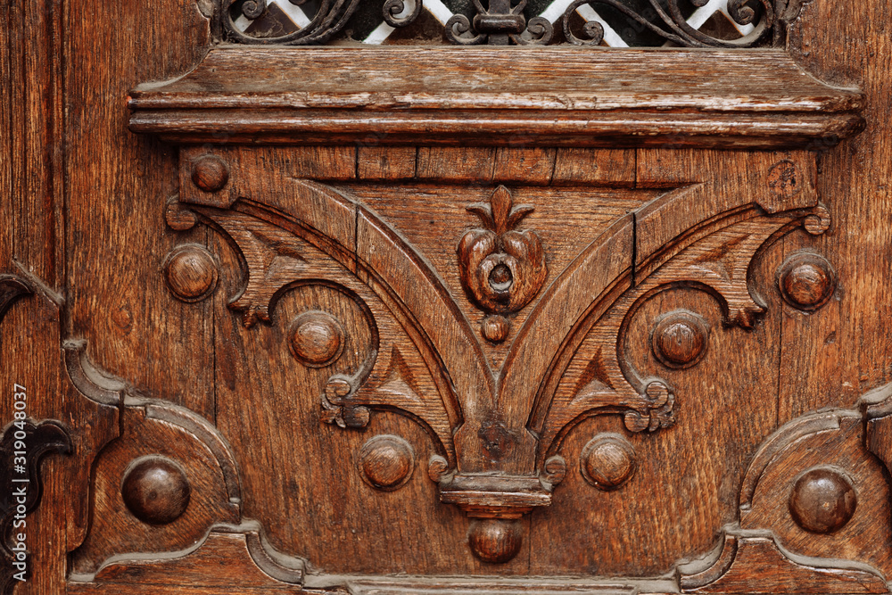 carved old wooden door with beautiful patterns. selective focus carved old wooden door with beautiful patterns. selective focus