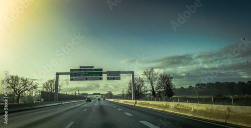 Fototapeta Naklejka Na Ścianę i Meble -  High speed highway with signage against dark sky