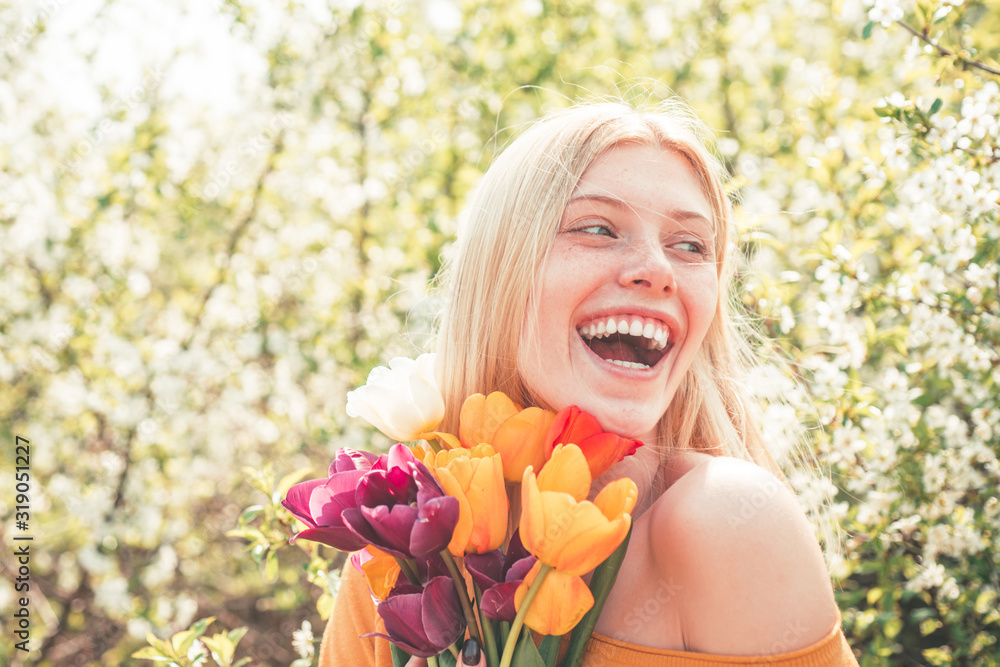 Womens day, 8 march. Funny woman relaxing in the tulip fields. Womens day, 8 march. Field of colorful bright red tulips. Womens day, 8 march. Funny woman relaxing in the tulip fields. Womens day, 8 march. Field of colorful bright red tulips.