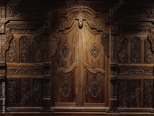 Javanesse door with javanesse batik and flower Pattern is carved on wood background