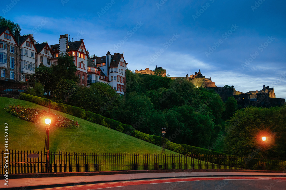 Street view on Old buildings and Edinburgh Castle on the hill in Scotland in the UK. Late in the evening Street view on Old buildings and Edinburgh Castle on the hill in Scotland in the UK. Late in the evening
