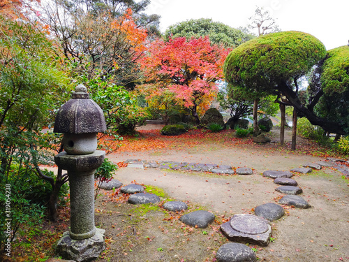 Traditional Japanese garden of Ohara-tei samurai residence (rebuilt in 1800) of in autumn colors. Many samurai houses survived in Kitsuki town (Japan) since Edo period photo