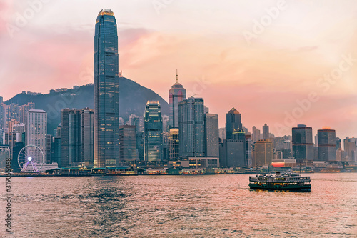 Photography Star ferry at Victoria Harbor in Hong Kong skyline at sunset