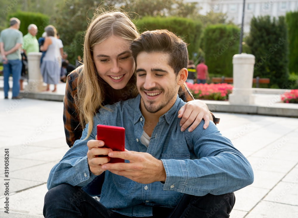 Young couple on social media posting on their online blog using smartphone Young couple on social media posting on their online blog using smartphone