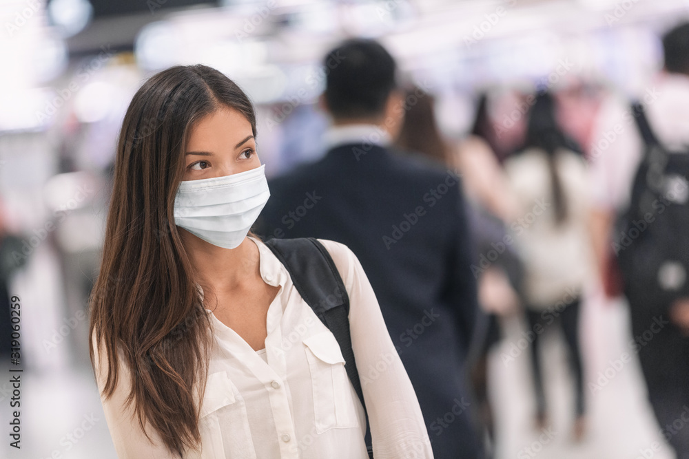 Fototapeta Virus mask Asian woman travel wearing face protection in prevention for coronavirus in China. Lady walking in public space bus station or airport.