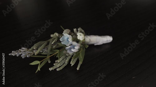 Wedding boutonniere on the table. Camera access. photo