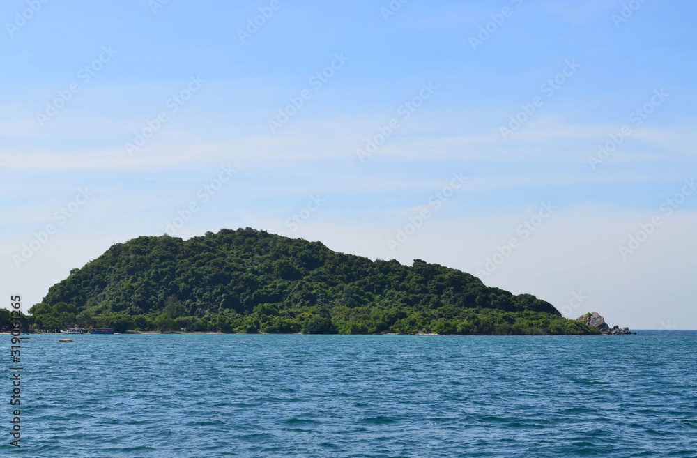 Beautiful green island against blue sky