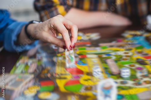 Process of playing board game and having fun with friends and family, board game concept, hand playing and roll the dice