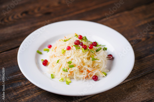 Pickled cabbage with carrots and cranberries. Preserved food, tasty snack, fermented product
