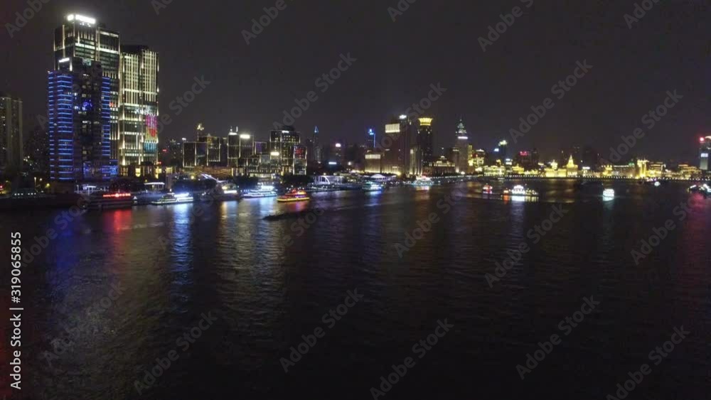 AERIAL shot of tour boats traverse Shanghai's scenic Huangpu River at dusk,China AERIAL shot of tour boats traverse Shanghai's scenic Huangpu River at dusk,China
