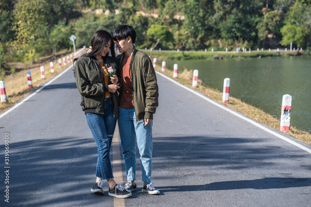 A couple of LGBT Lesbian holding hands each other while standing on road A couple of LGBT Lesbian holding hands each other while standing on road