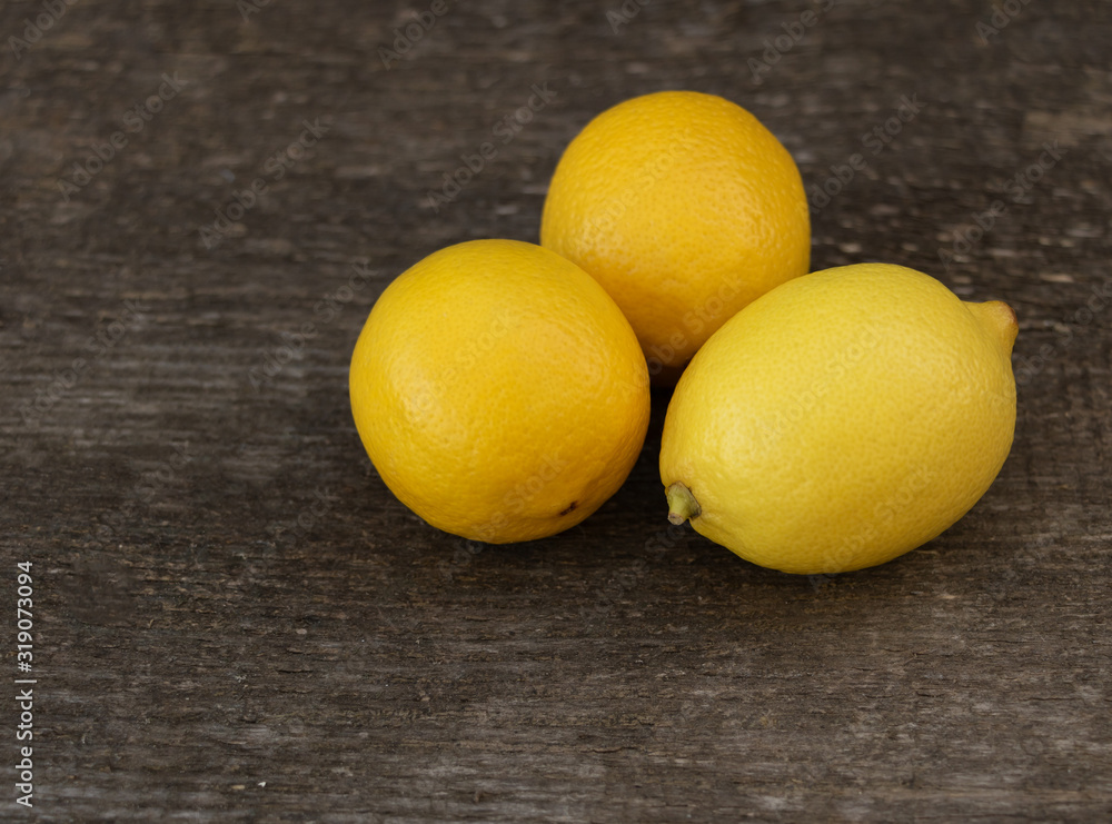 Lemon on wooden background. Health benefits concept