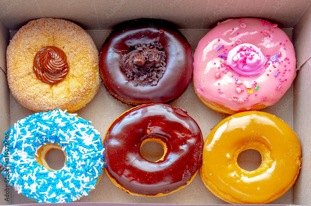 Top view Inside of a Tim Hortons six donuts box, with a Dulce de Leche, Chocolate Truffle