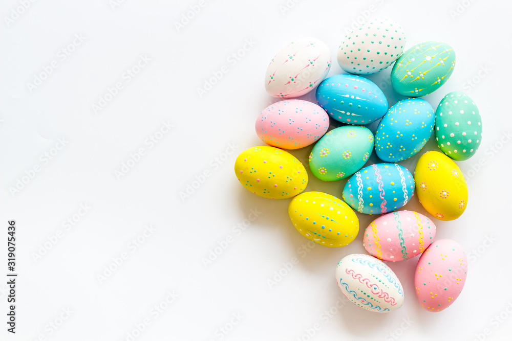 Easter eggs painted in pastel colors on white background top-down copy space Easter eggs painted in pastel colors on white background top-down copy space