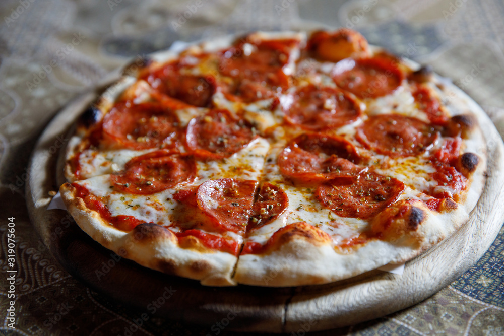 Pepperoni pizza on wood plate italian food