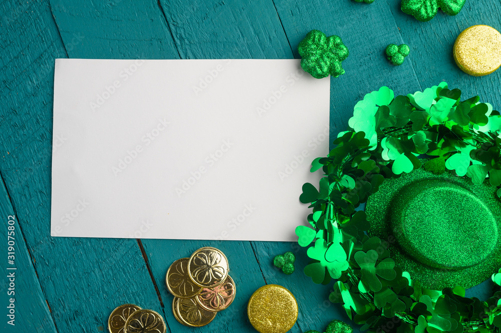 Flat lay, St. Patrick's Day, white card for congratulation. March 17, on a green background with accesories for a celebration, a traditional Irish holiday