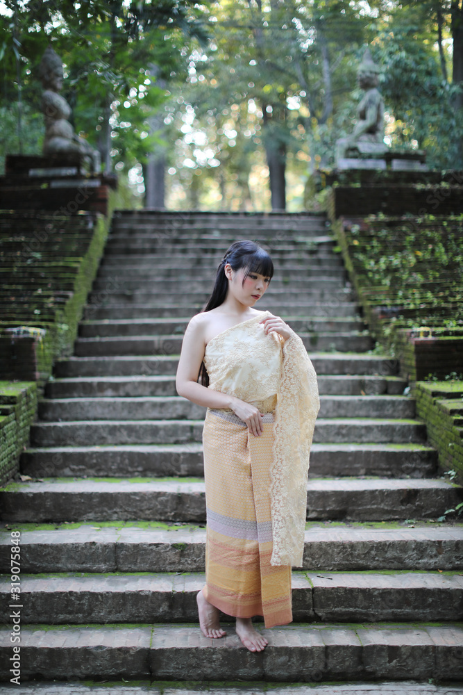 Portrait of Thai female with traditional Thai dress with temple background Portrait of Thai female with traditional Thai dress with temple background