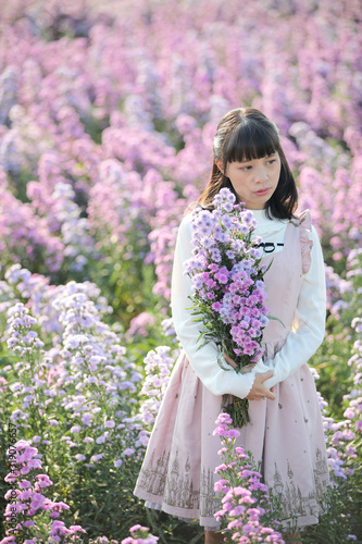 Portrait asian girl with purple flowers background