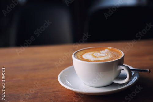 cappuccino or Latte art coffee made from milk on the wood table in coffee shop
