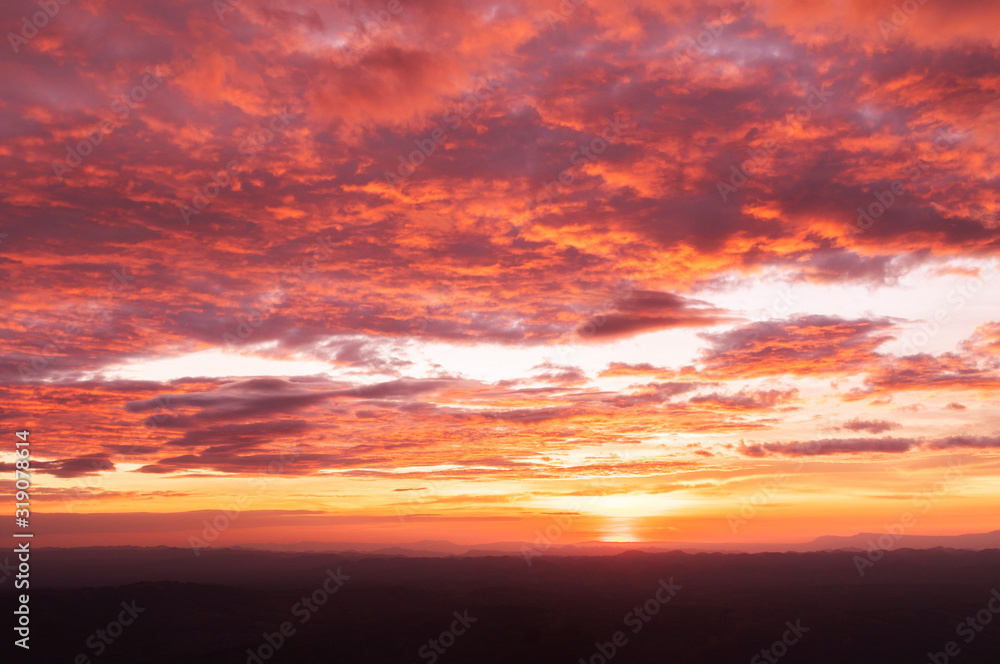 Beautiful red vibrant burning sunset sky with clouds
