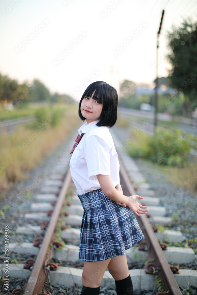 Asian school girl walking in urban city Asian school girl walking in urban city