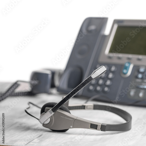 Bild auf Leinwand VOIP headset headphones telephone on office desk concept for communication, it support, call center and customer service help desk