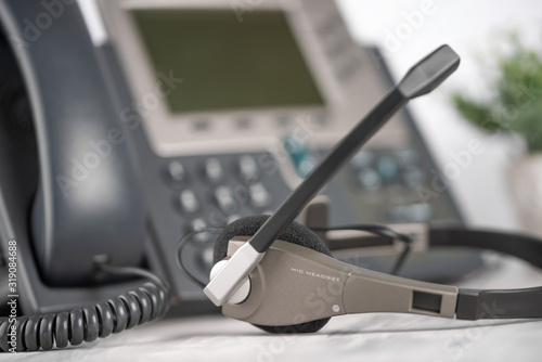 VOIP headset headphones telephone on office desk concept for communication