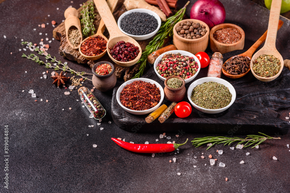 Spices and herbs over black stone background. Top view with free space for menu or recipes Spices and herbs over black stone background. Top view with free space for menu or recipes