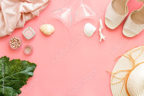 Shopping concept. Women clothes, cosmetics, shoes on pink background top-down frame copy space