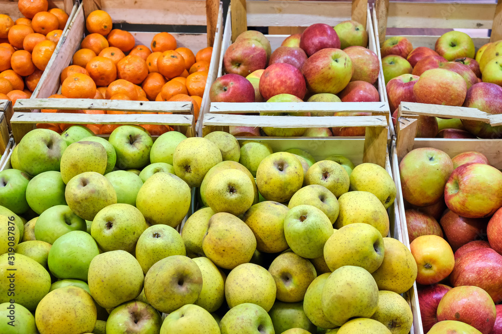 Apples and tangerines for sale at a market Apples and tangerines for sale at a market