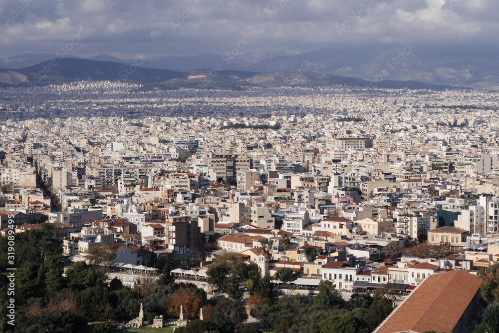 Athens, Greece - Dec 20, 2019: View from the entrance of the Acropolis of Athens towards the Ancient Agora and across the city of Athens, Greece