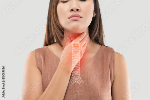 Asian women have symptoms of burning sensation on a gray background photo