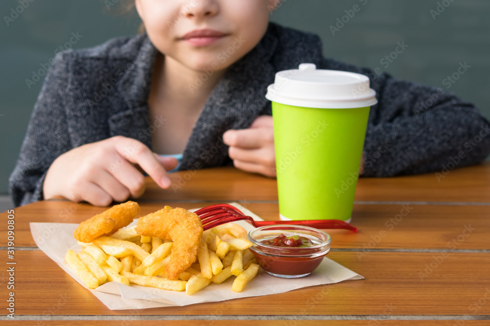 girl having lunch at a restaurant with potatoes and shrimp with a hot drink girl having lunch at a restaurant with potatoes and shrimp with a hot drink